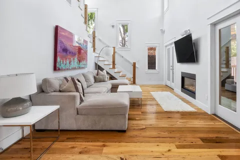 a living room with furniture flat screen tv and a fireplace