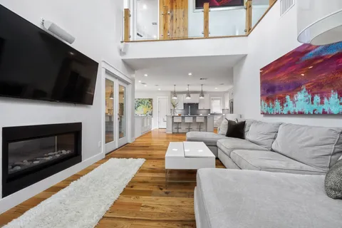a living room with furniture a fireplace and a flat screen tv