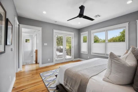 a bedroom with a large bed and a large window