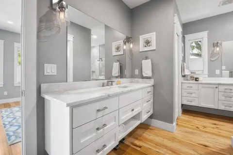 a bathroom with a granite countertop sink mirror and