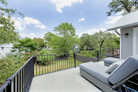 a view of a roof deck with couches and wooden floor