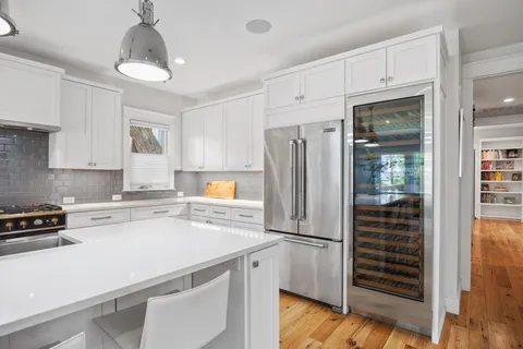 a kitchen with a refrigerator and a stove top oven