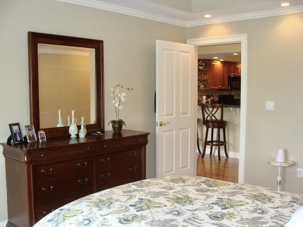 a bedroom with a bed and a dresser in it