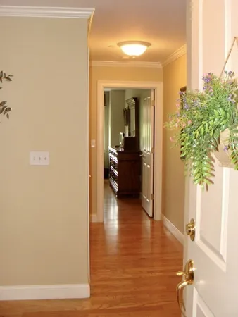 a view of a hallway to a livingroom with furniture