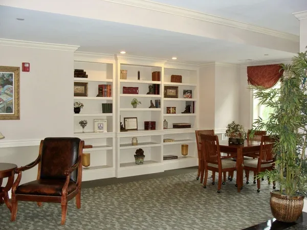 a view of a workspace with furniture and a window