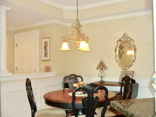 a view of a dining room with furniture and chandelier