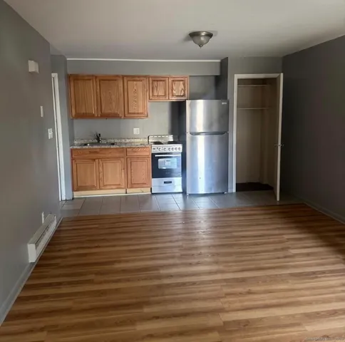 a kitchen with stainless steel appliances granite countertop a refrigerator and a stove