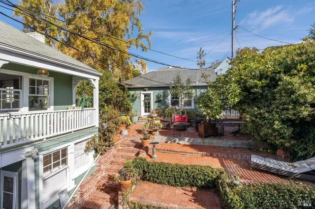a view of a house with sitting area and garden