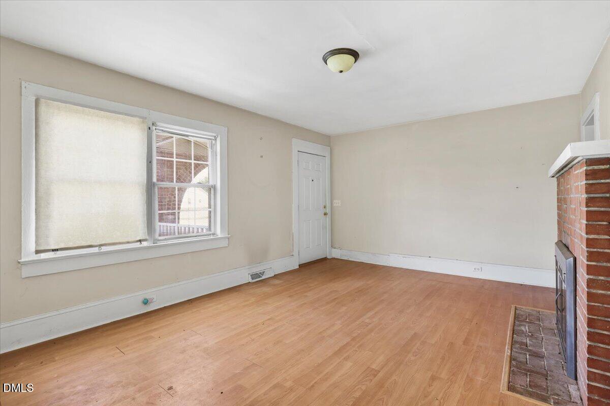 2213 Hunter Hill Road Rocky Mount, NC 27804 - Photo 3 of 11 an empty room with wooden floor and windows