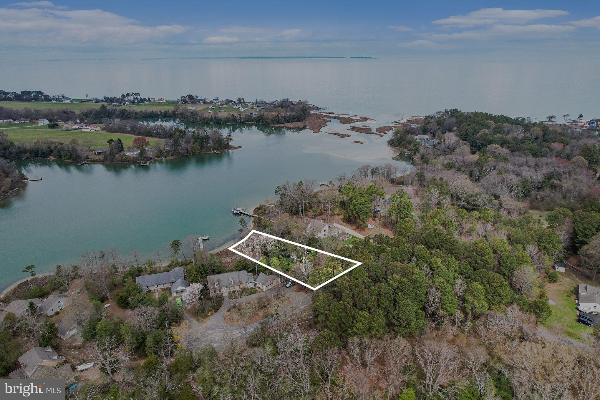 Scenic waterfront lot awaits your vision.