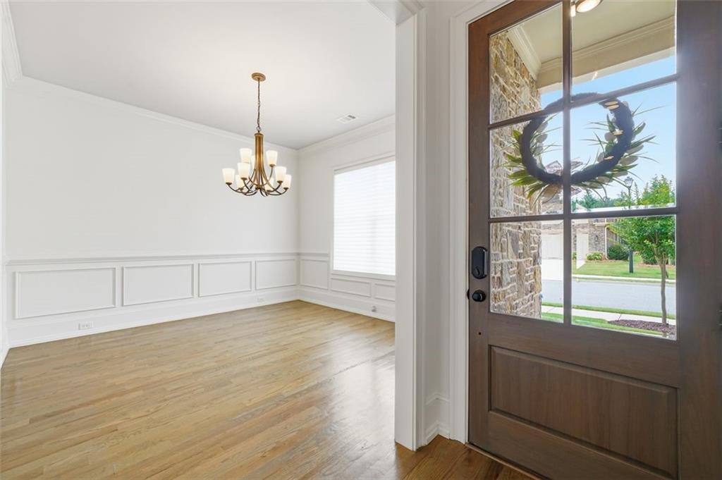 337 Rosshandler Road Suwanee, GA 30024 - Photo 3 of 45 a view of an empty room with wooden floor and a window