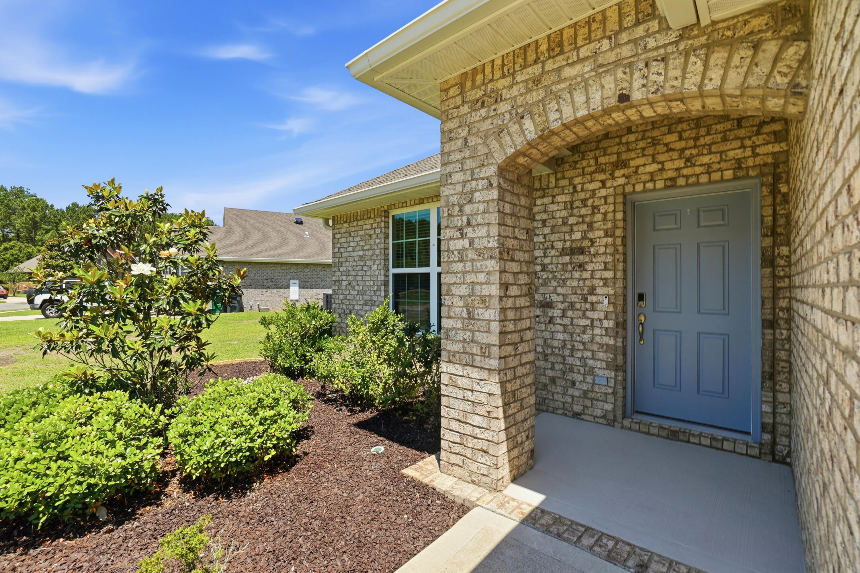 525 Windchime Way Freeport, FL 32439 - Photo 3 of 59 a front view of a house with a garden