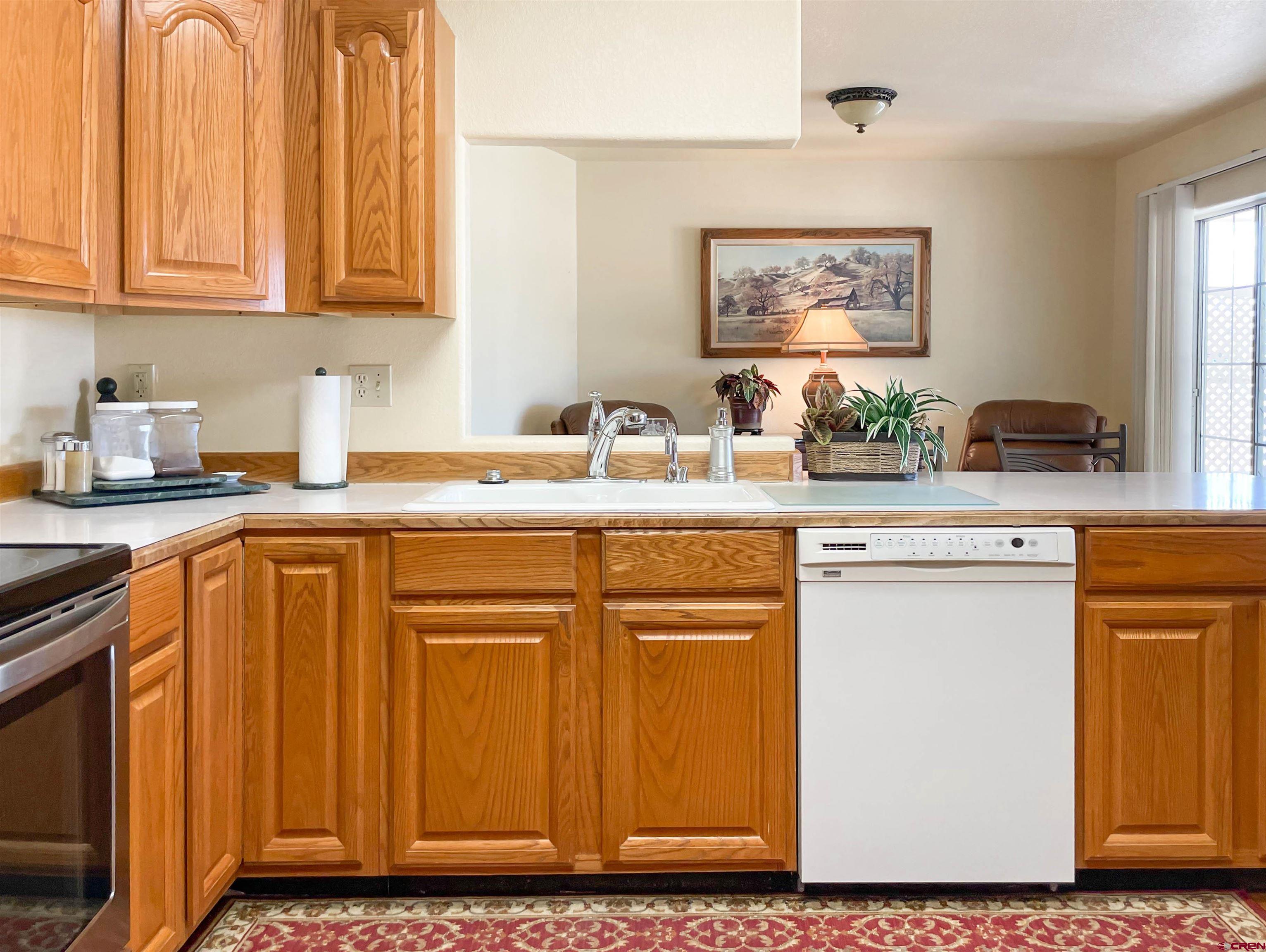 2535 1585 Road Delta, CO 81416 - Photo 11 of 35 a kitchen with stainless steel appliances granite countertop a sink stove and refrigerator