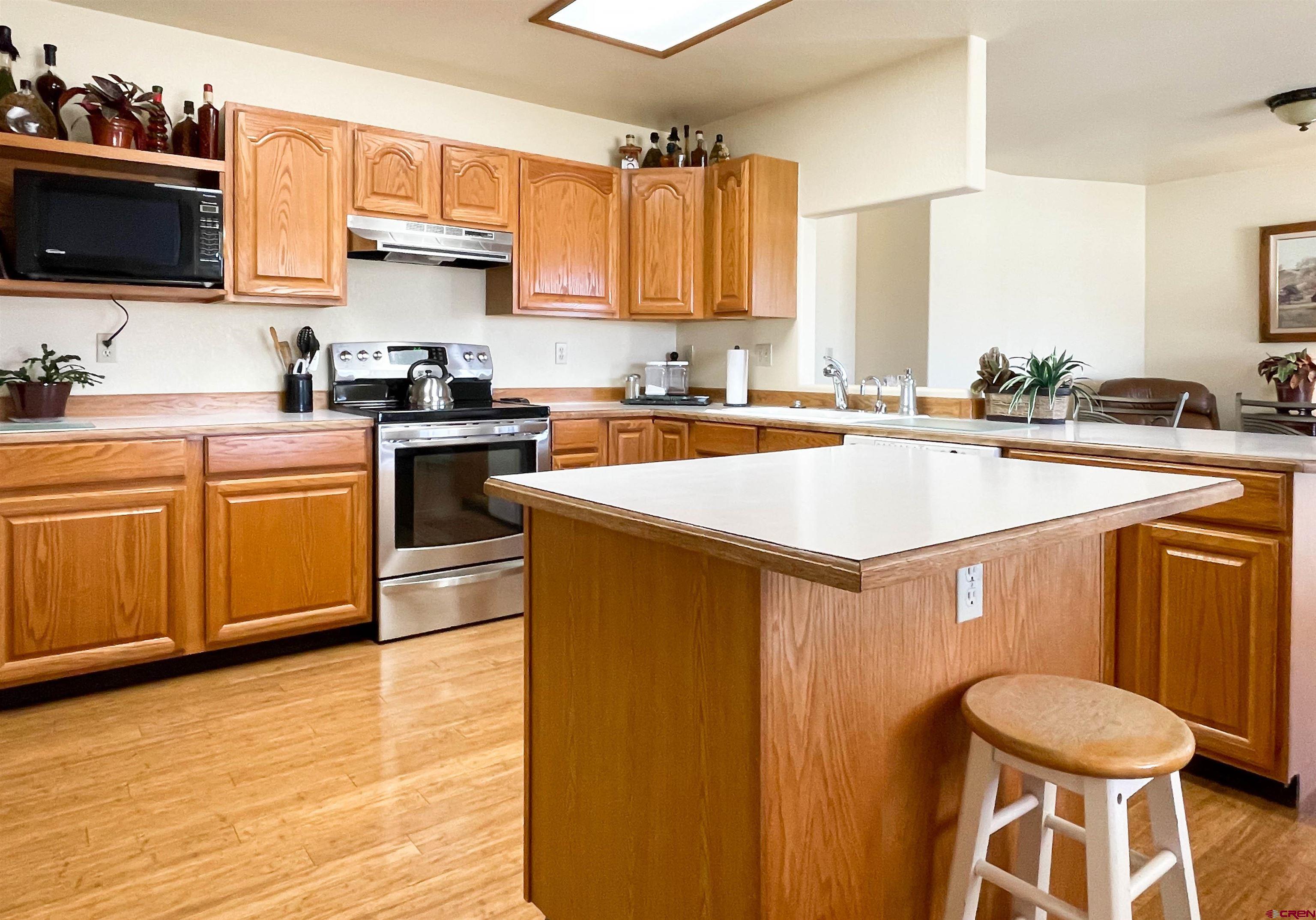 2535 1585 Road Delta, CO 81416 - Photo 12 of 35 a kitchen with a sink a stove and cabinets