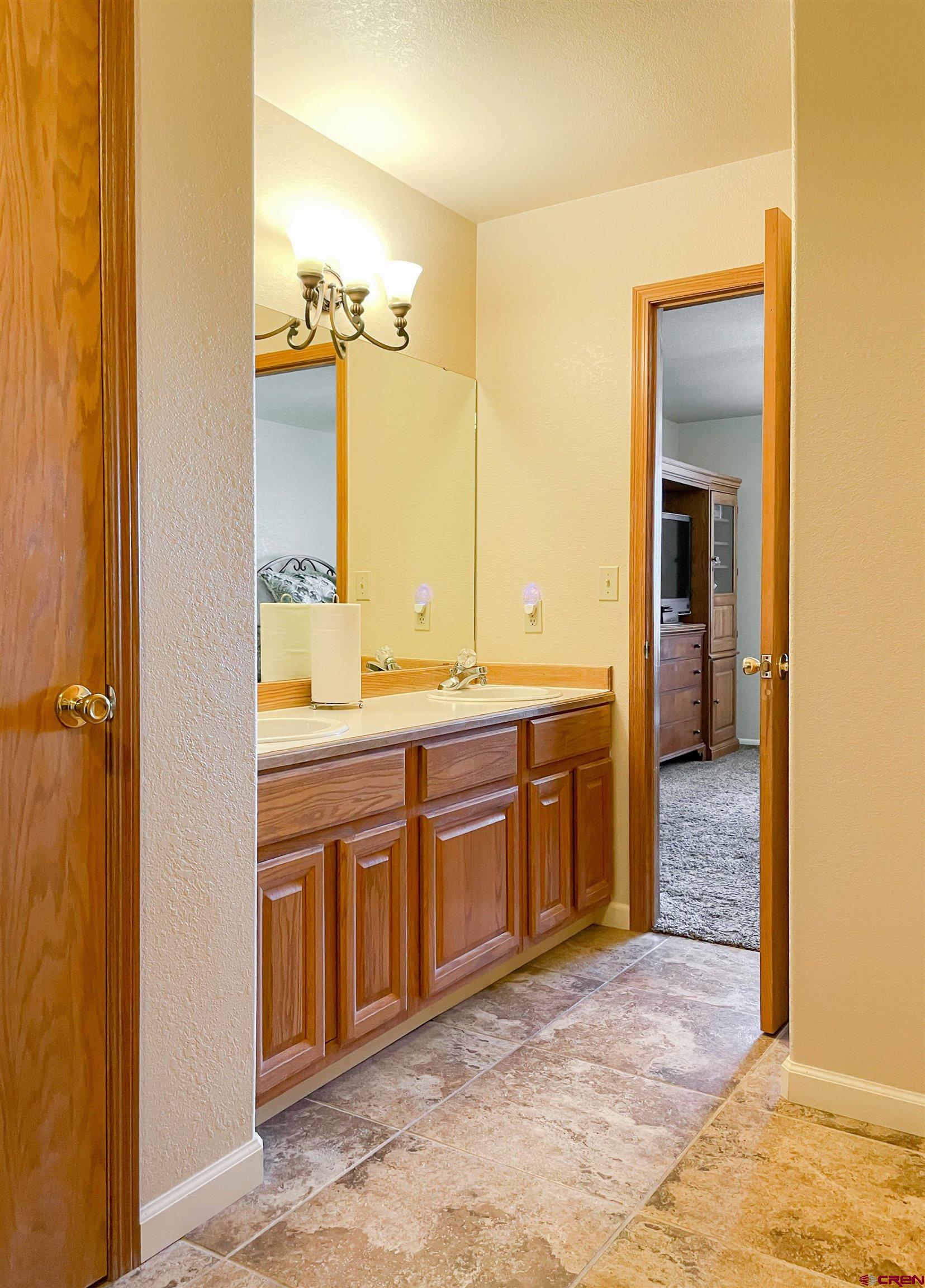 2535 1585 Road Delta, CO 81416 - Photo 18 of 35 a spacious bathroom with a granite countertop sink a mirror and a