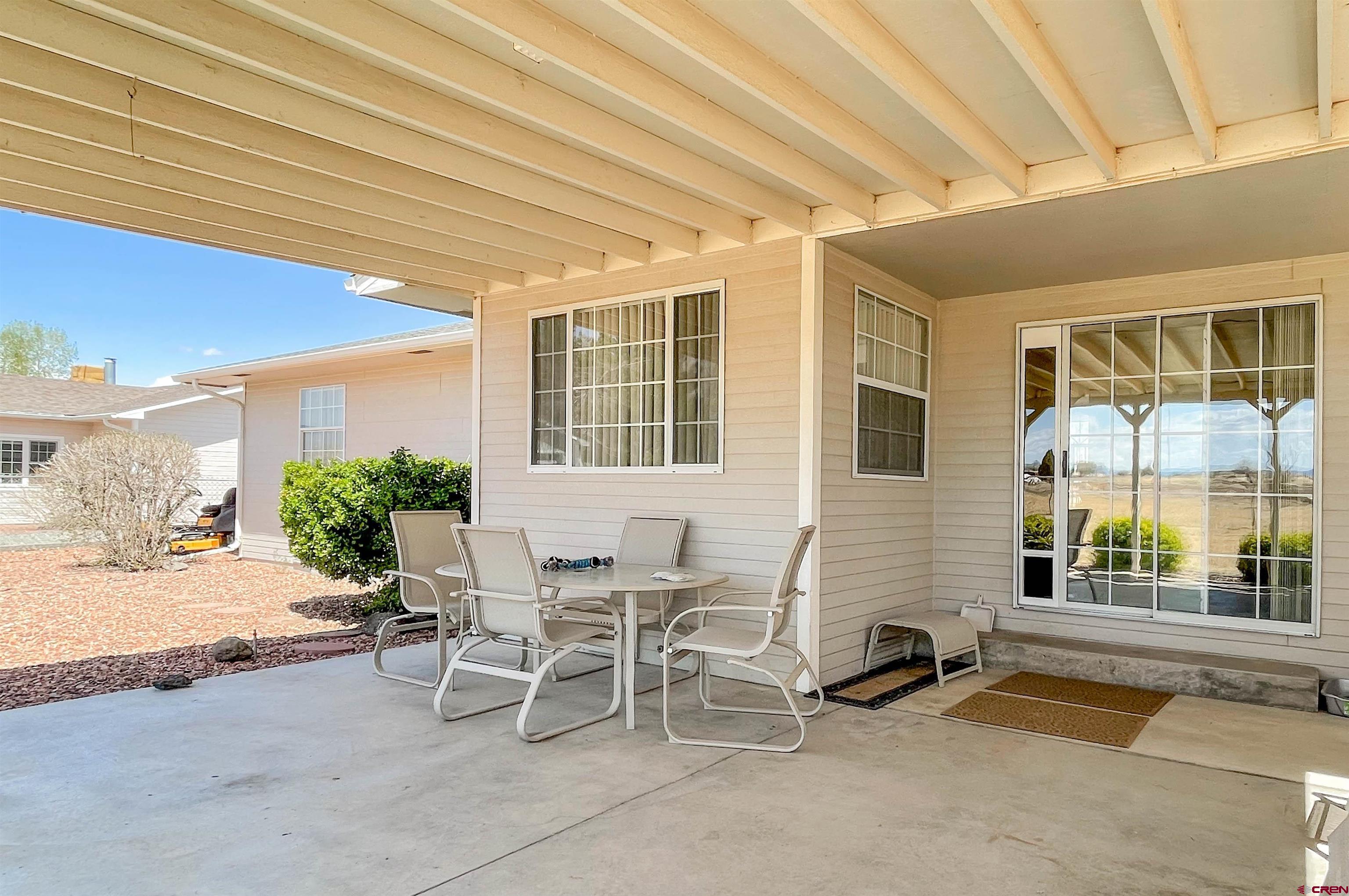 2535 1585 Road Delta, CO 81416 - Photo 26 of 35 a view of a patio with table and chairs and potted plants