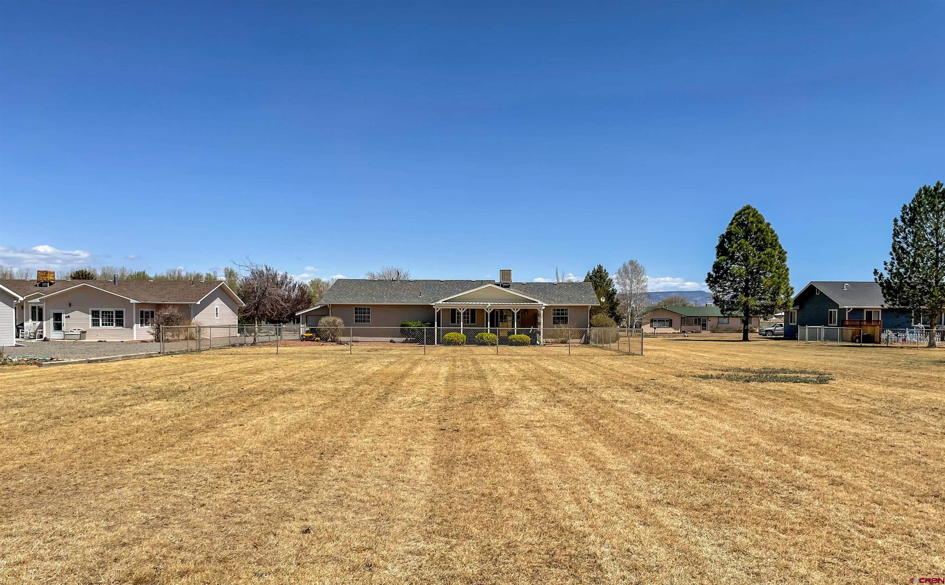 2535 1585 Road Delta, CO 81416 - Photo 33 of 35 a front view of a house with a yard and mountain view