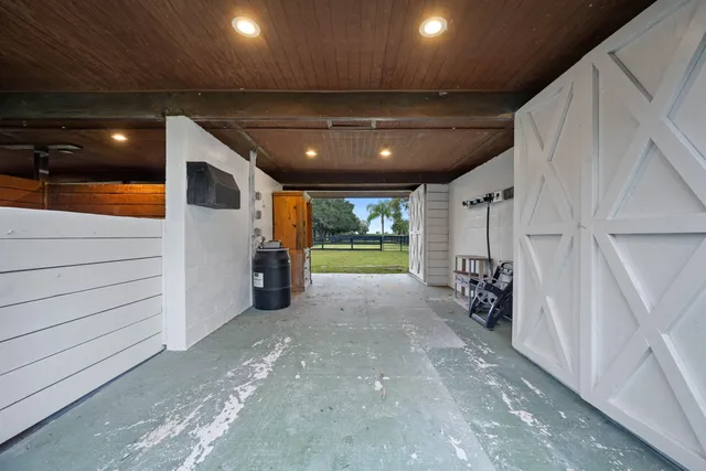 a kitchen with stainless steel appliances kitchen island granite countertop a table chairs and a refrigerator