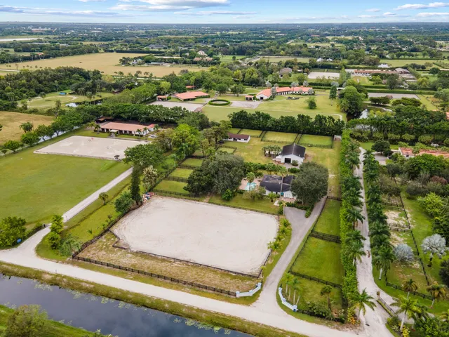 an aerial view of a residential houses with outdoor space and river