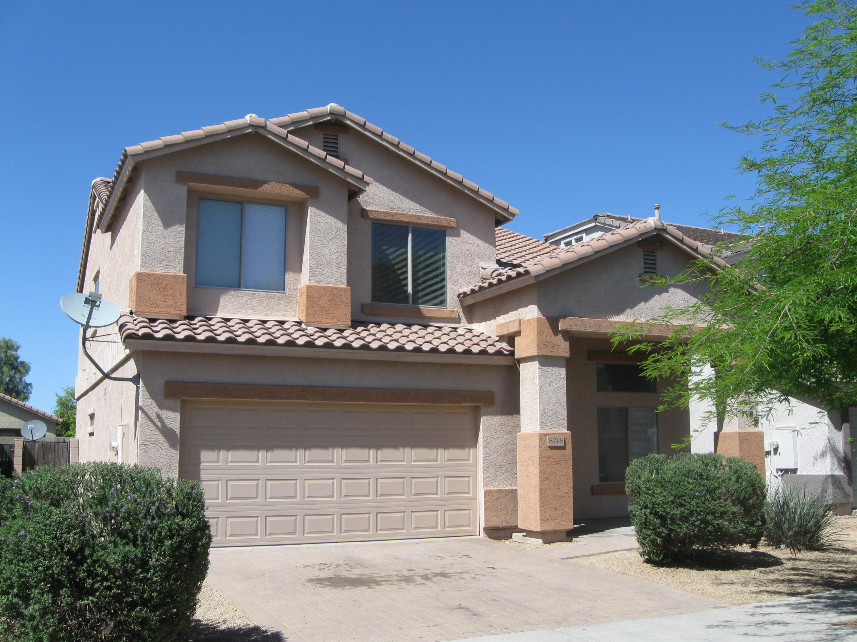 a front view of a house with a garage