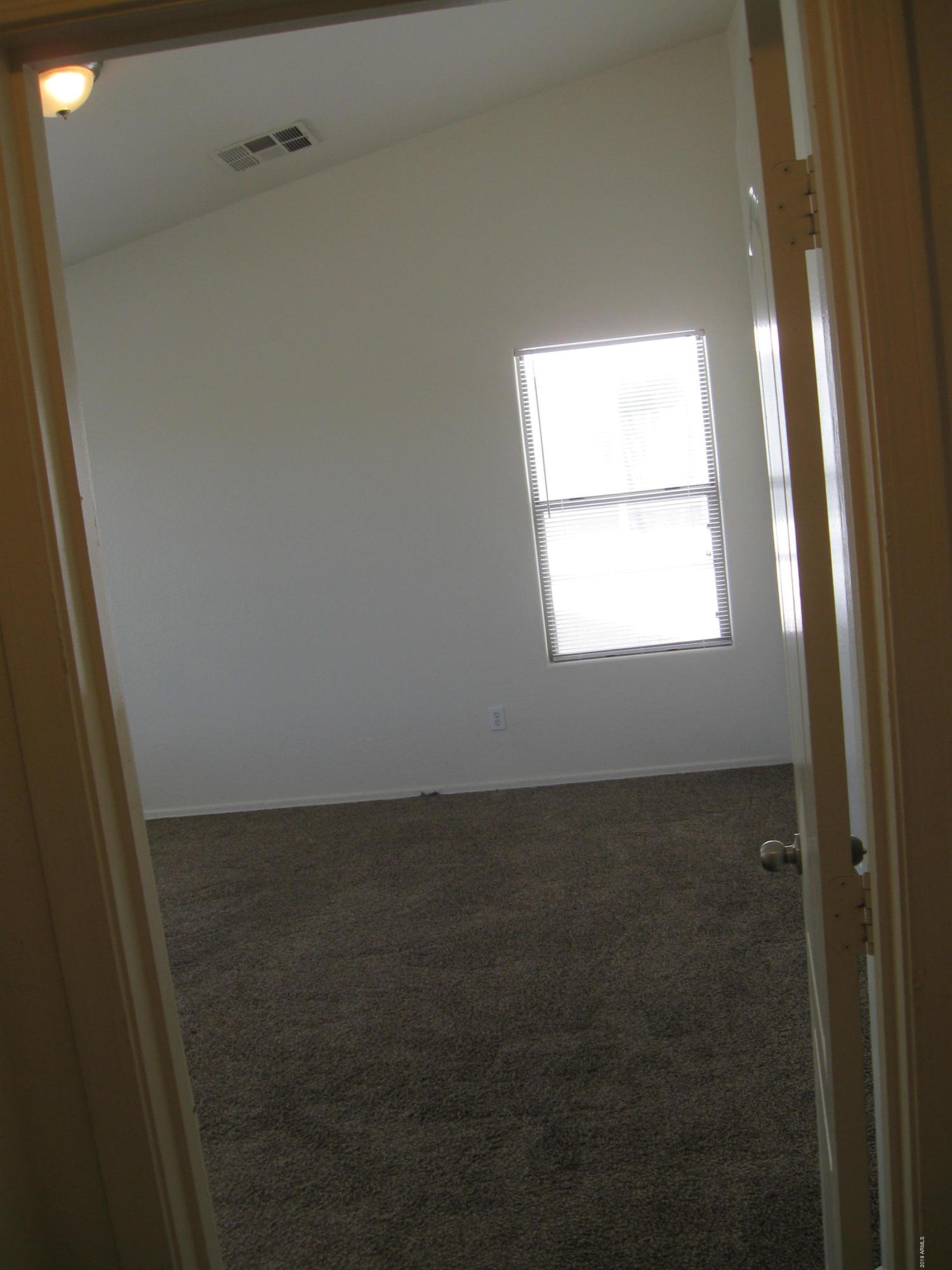 8746 West Heber Road Tolleson, AZ 85353 - Photo 13 of 36 a view of an empty room and window