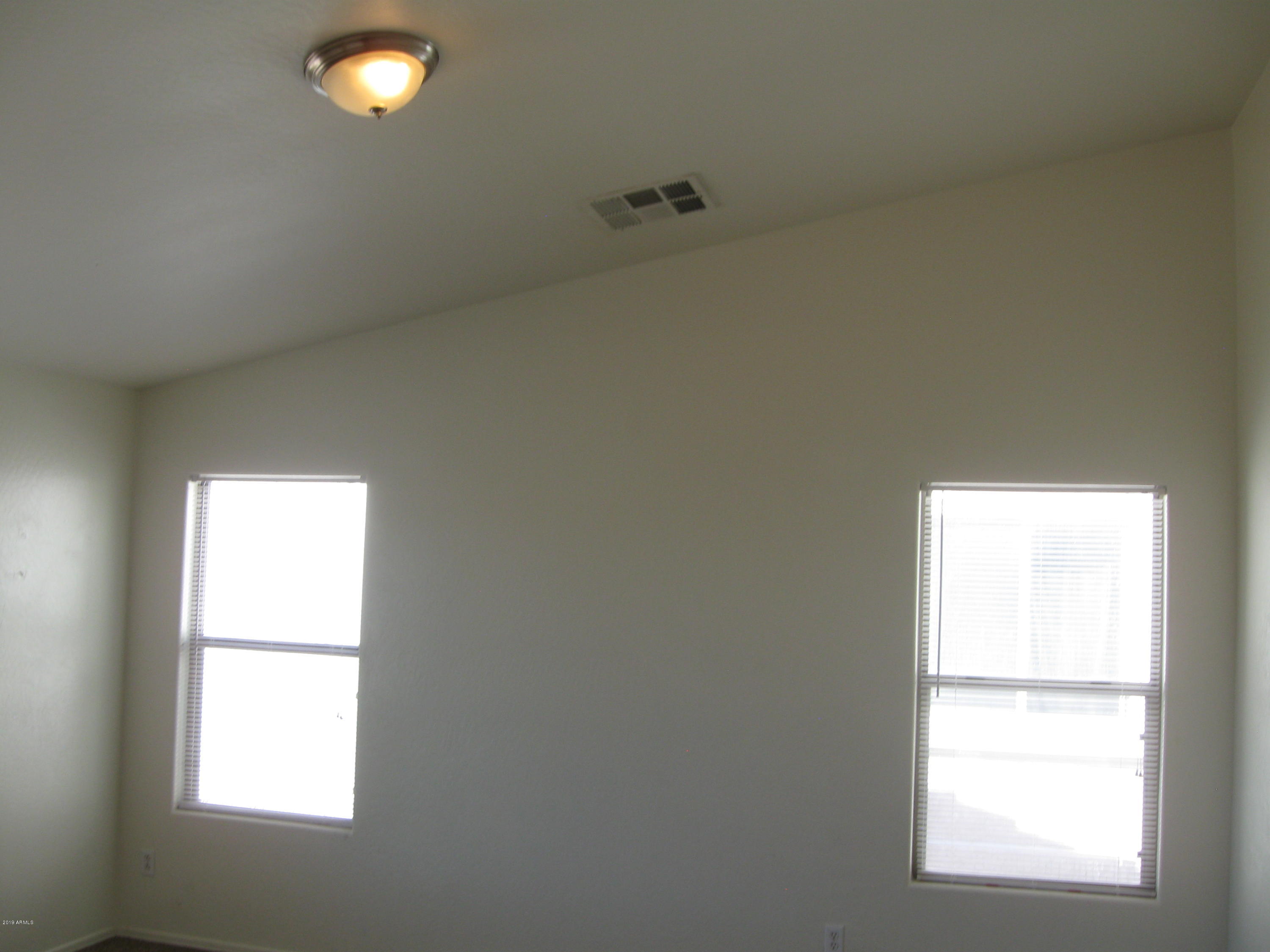 8746 West Heber Road Tolleson, AZ 85353 - Photo 14 of 36 an empty room with a window