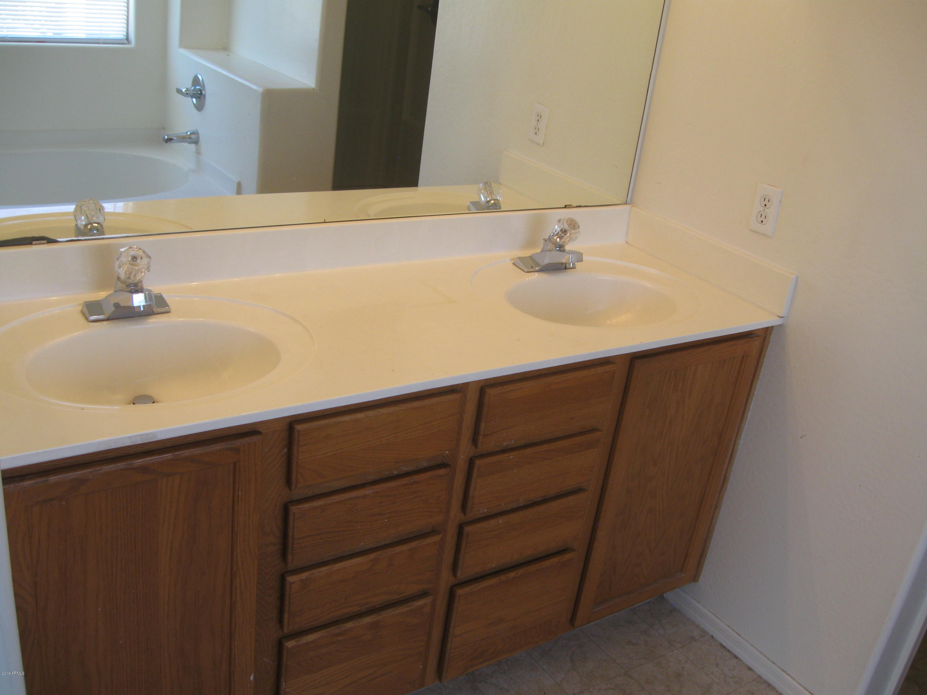 8746 West Heber Road Tolleson, AZ 85353 - Photo 17 of 36 a bathroom with a sink and a mirror