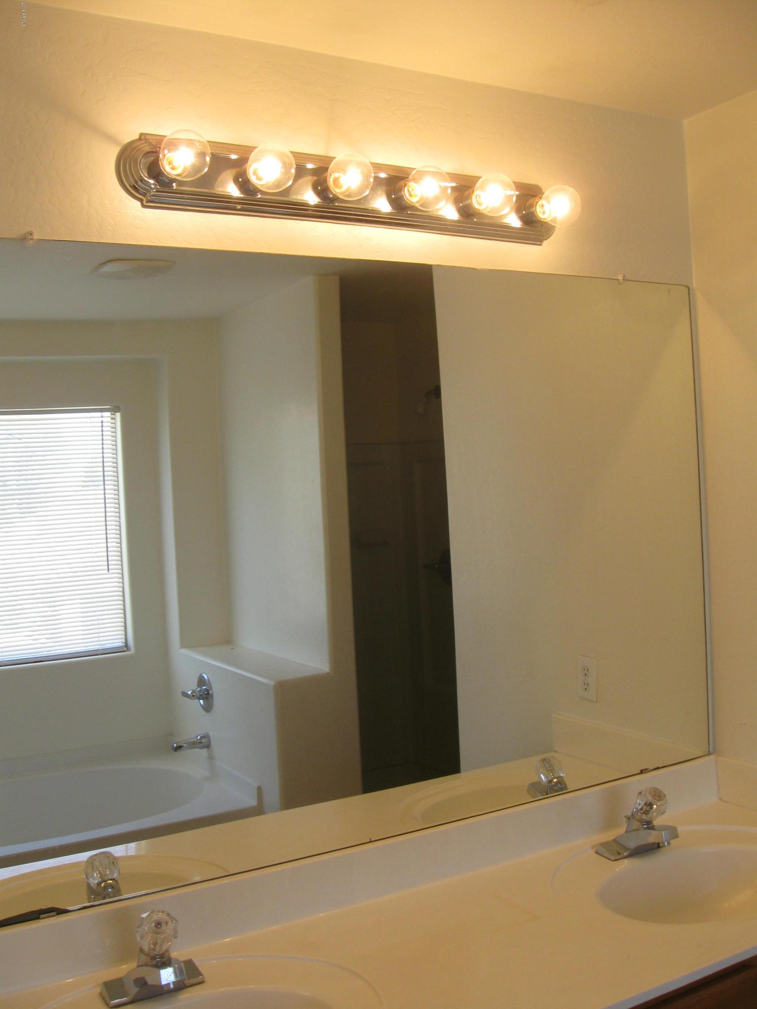 8746 West Heber Road Tolleson, AZ 85353 - Photo 18 of 36 a bathroom with a sink and a mirror