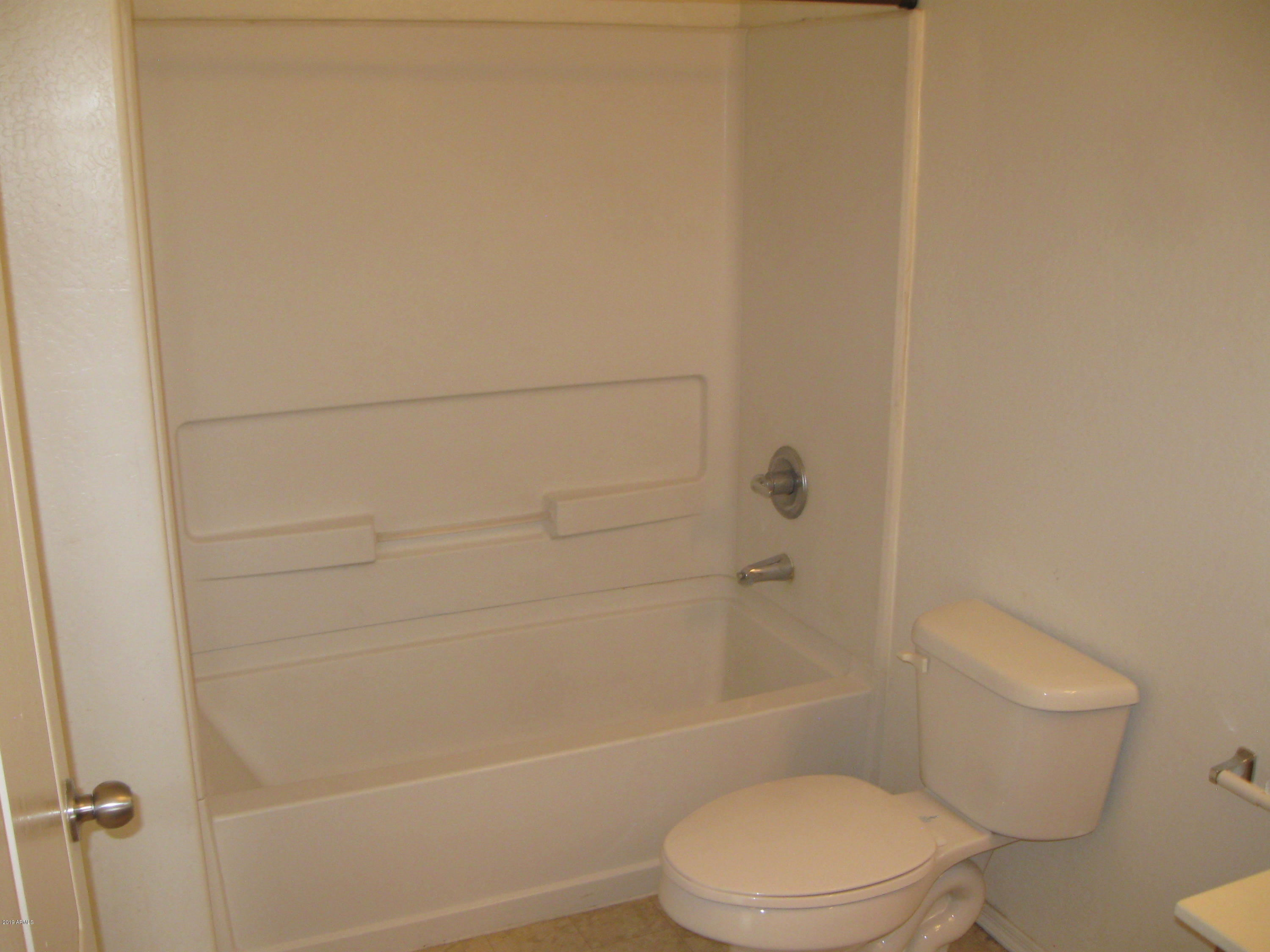 8746 West Heber Road Tolleson, AZ 85353 - Photo 25 of 36 a bathroom with a toilet and shower