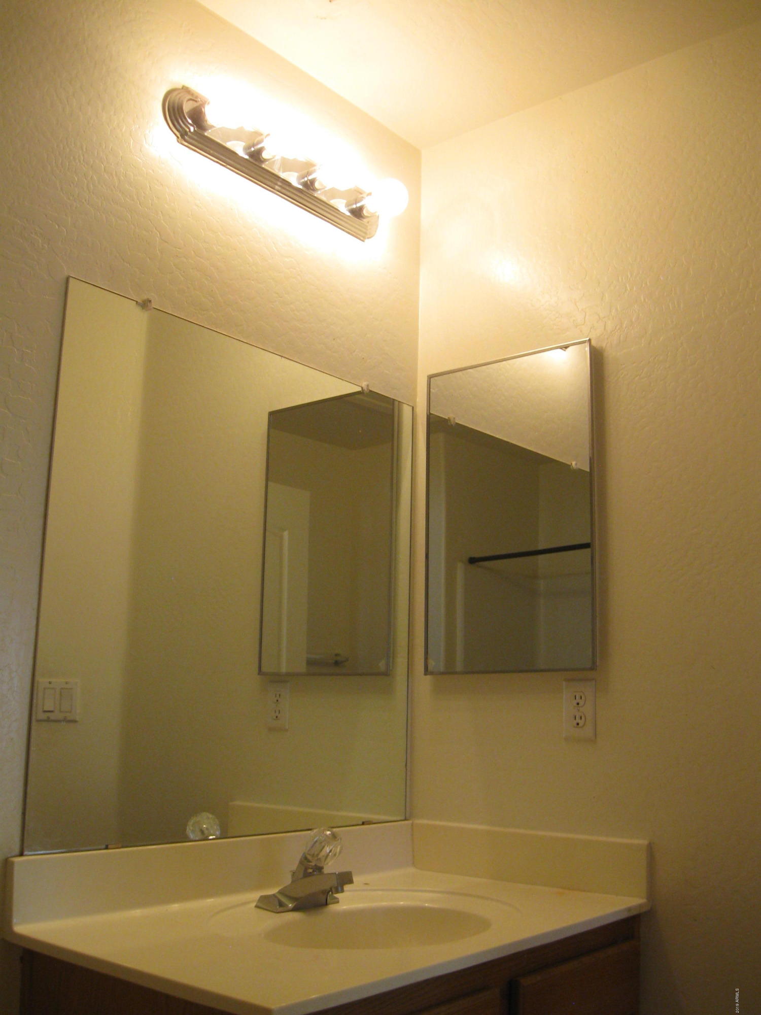 8746 West Heber Road Tolleson, AZ 85353 - Photo 26 of 36 a bathroom with a sink and mirror