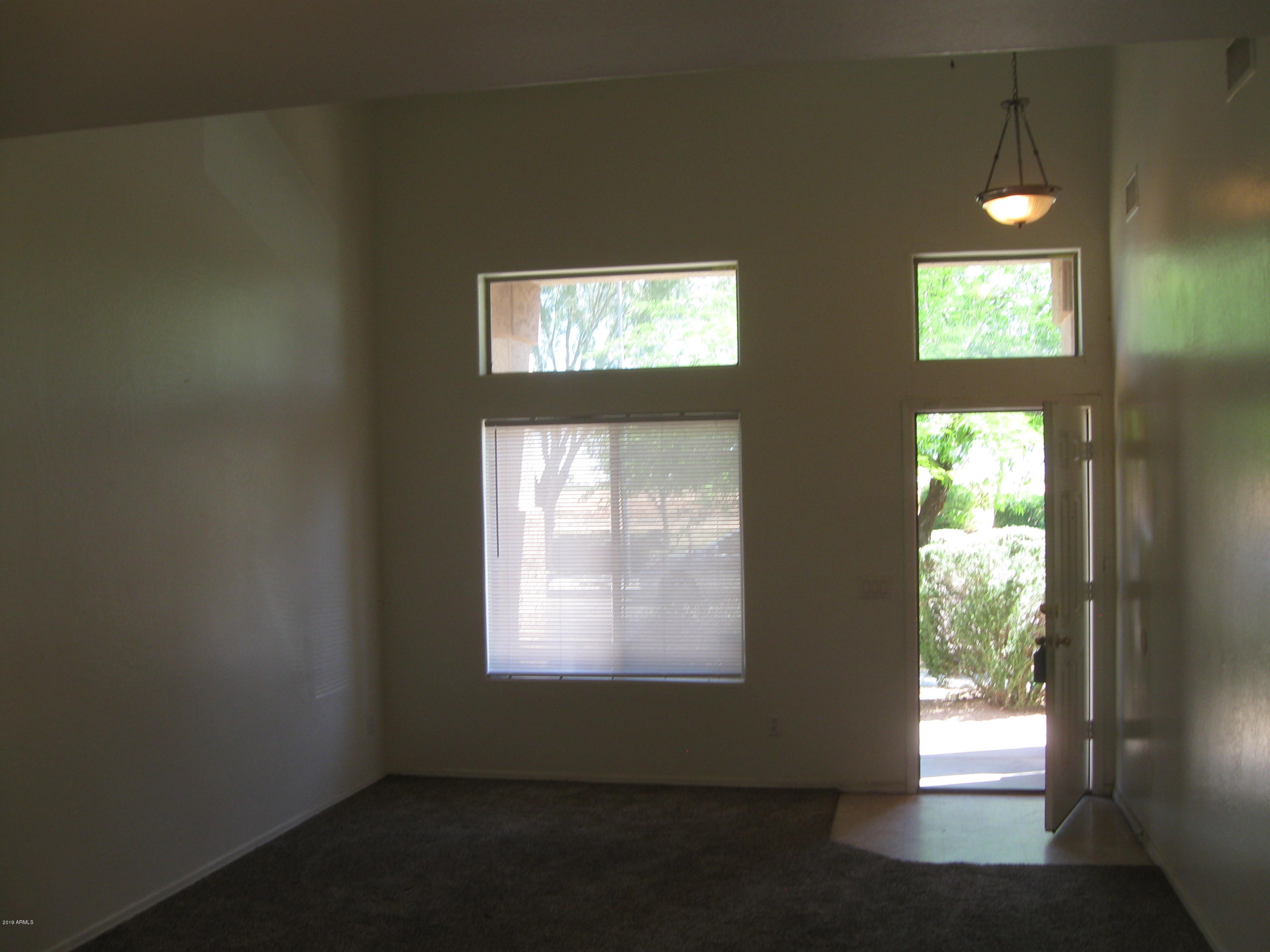 8746 West Heber Road Tolleson, AZ 85353 - Photo 3 of 36 a view of an empty room and window