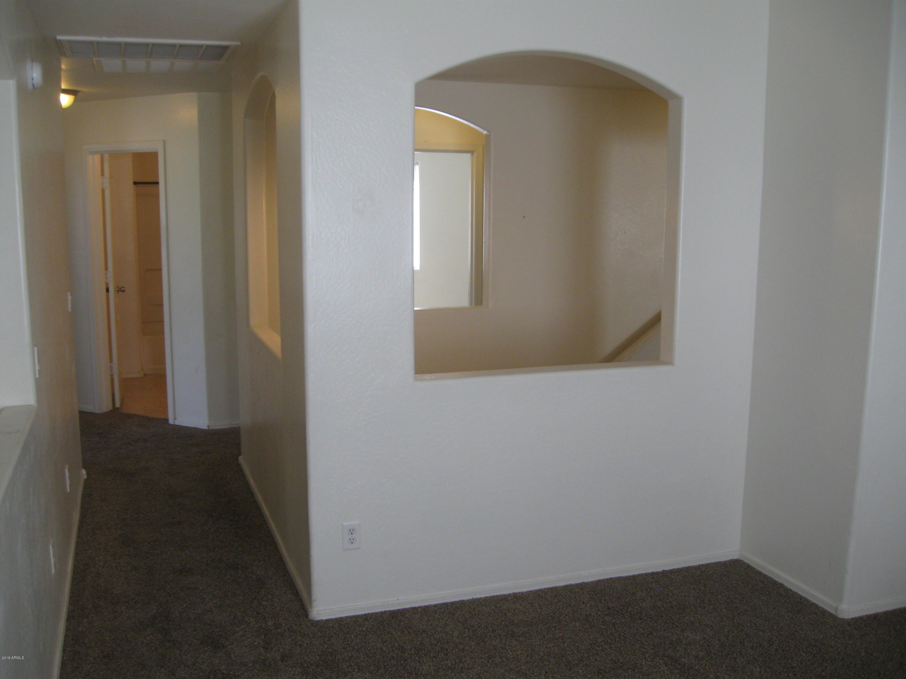 8746 West Heber Road Tolleson, AZ 85353 - Photo 32 of 36 a view of a hallway