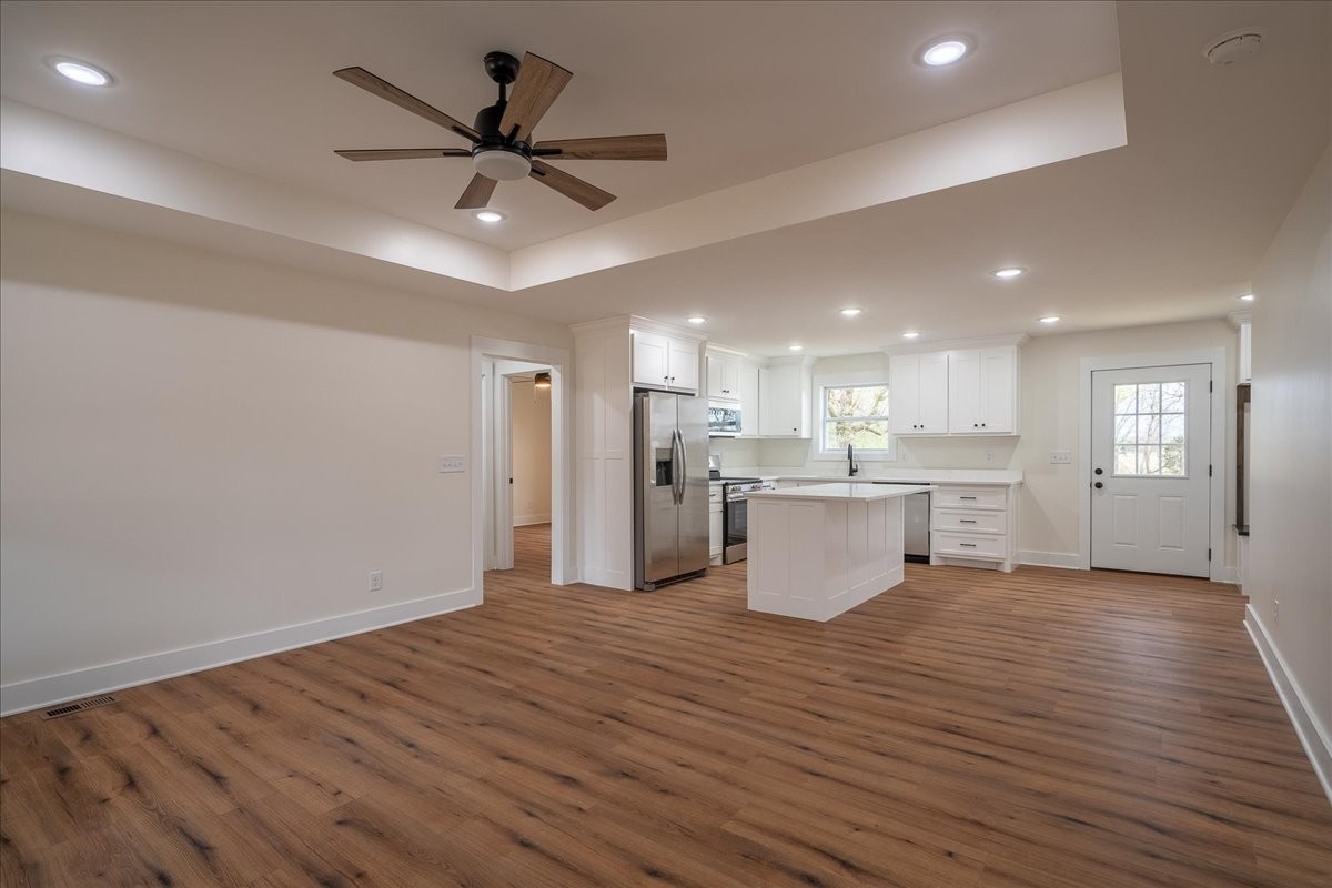 3987 Buffalo Road Summertown, TN 38483 - Photo 5 of 26 a view of an empty room and kitchen with wooden floor