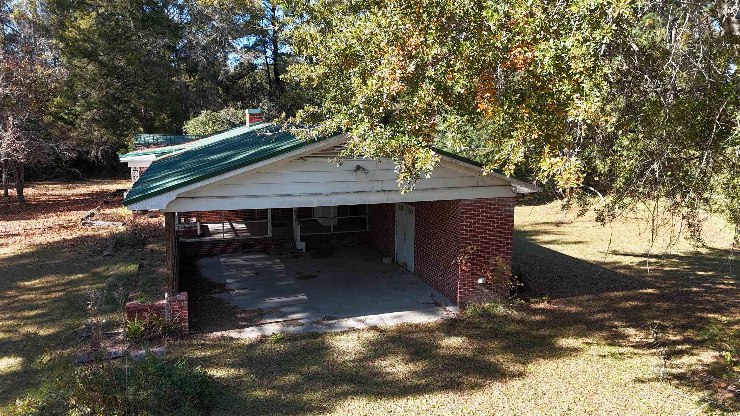 6800 State Rd S-26-266 Nichols, SC 29581 - Photo 17 of 20 View of property exterior with a carport and a patio