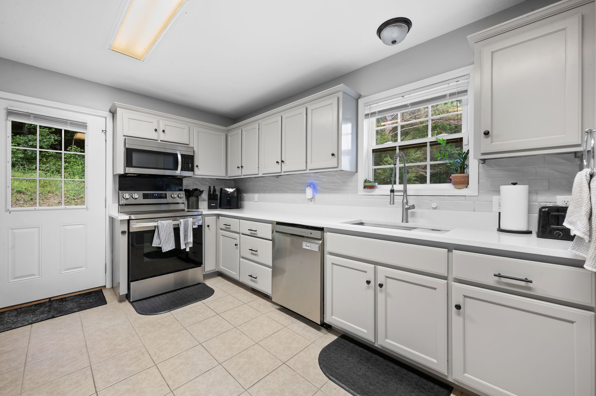 1197 Biter Road Cunningham, TN 37052 - Photo 6 of 38 a kitchen with cabinets stainless steel appliances and a window