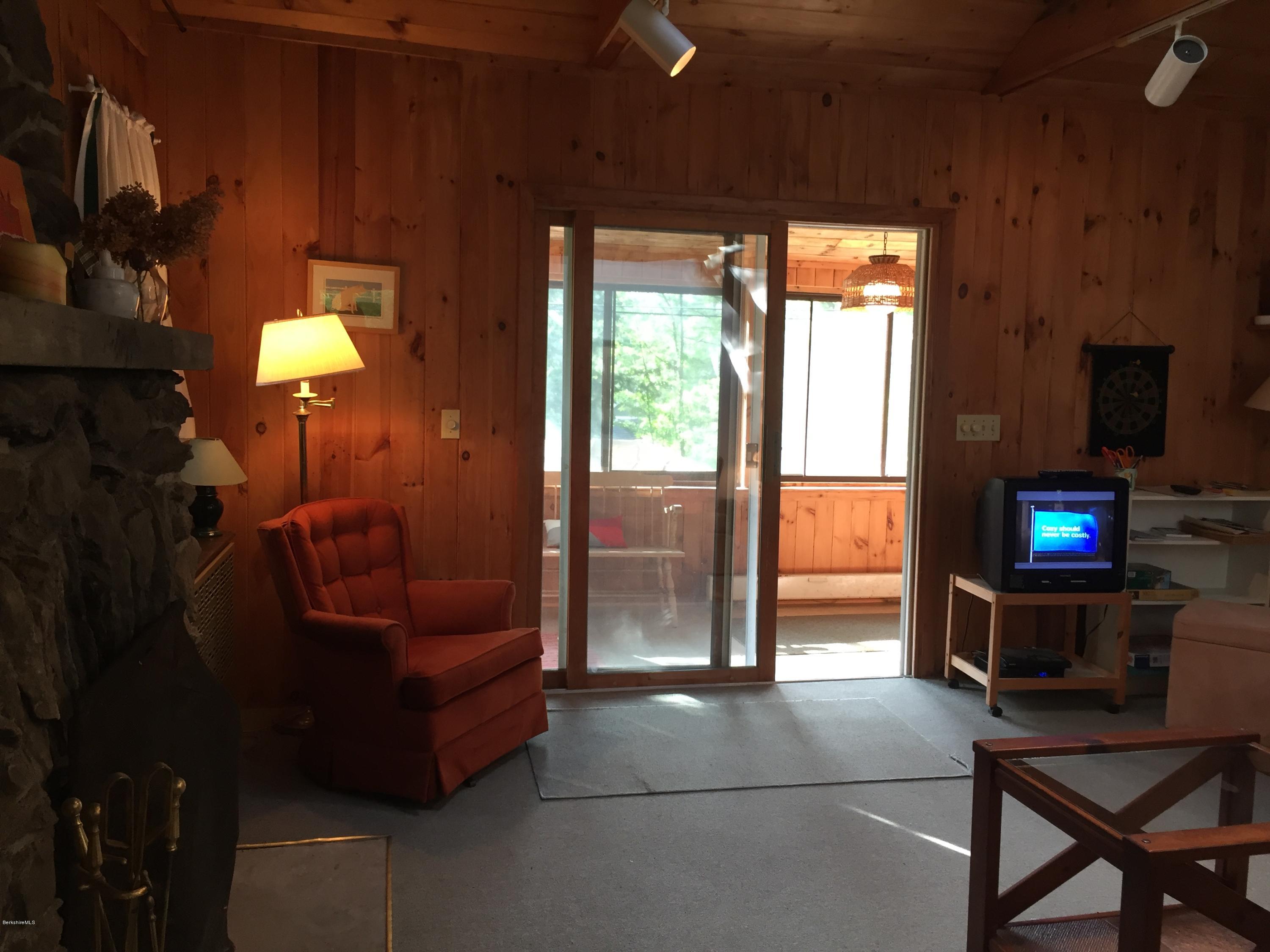 10 Mahkeenac Heights Road Stockbridge, MA 01262 - Photo 5 of 22 a view of a livingroom with furniture and a flat screen tv