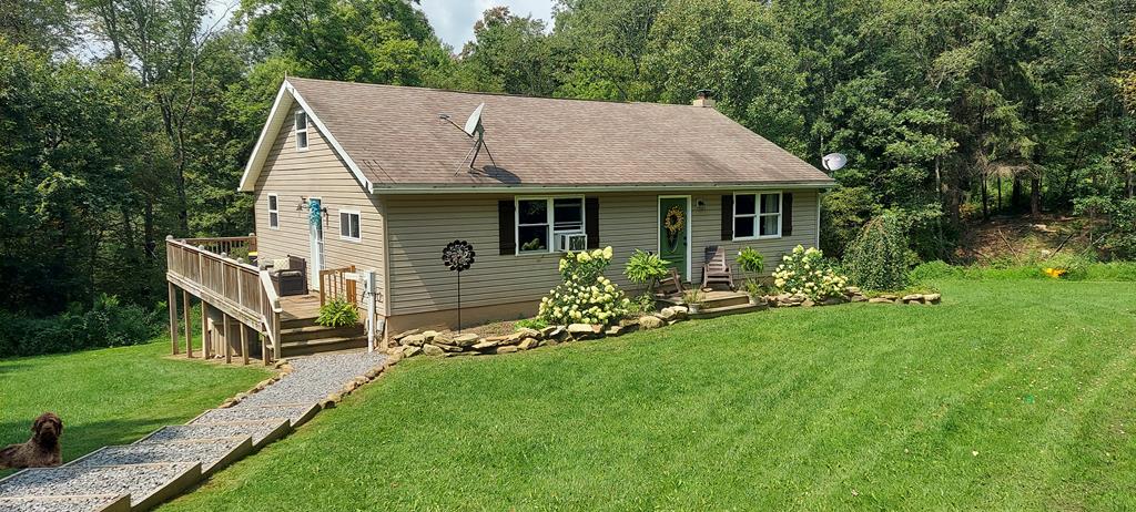 1647 Hells Kitchen Road Stoneboro, PA 16153 - Photo 1 of 19 a aerial view of a house with table and chairs under a large tree