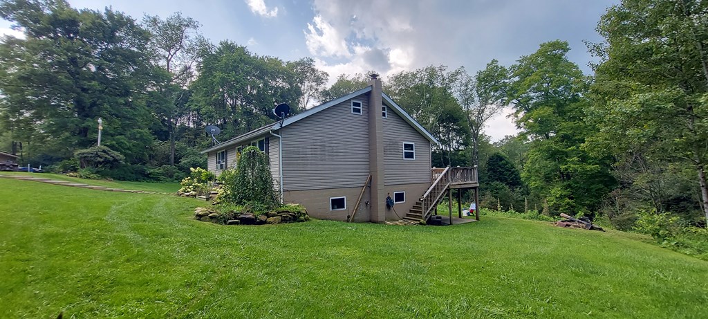 1647 Hells Kitchen Road Stoneboro, PA 16153 - Photo 4 of 19 a view of a house with backyard sitting area and garden