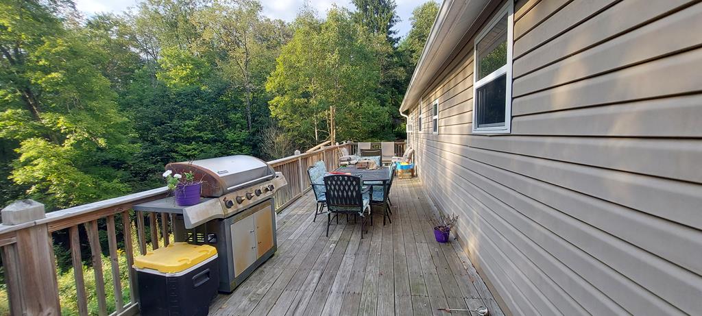 1647 Hells Kitchen Road Stoneboro, PA 16153 - Photo 6 of 19 a balcony with wooden floor table and chairs