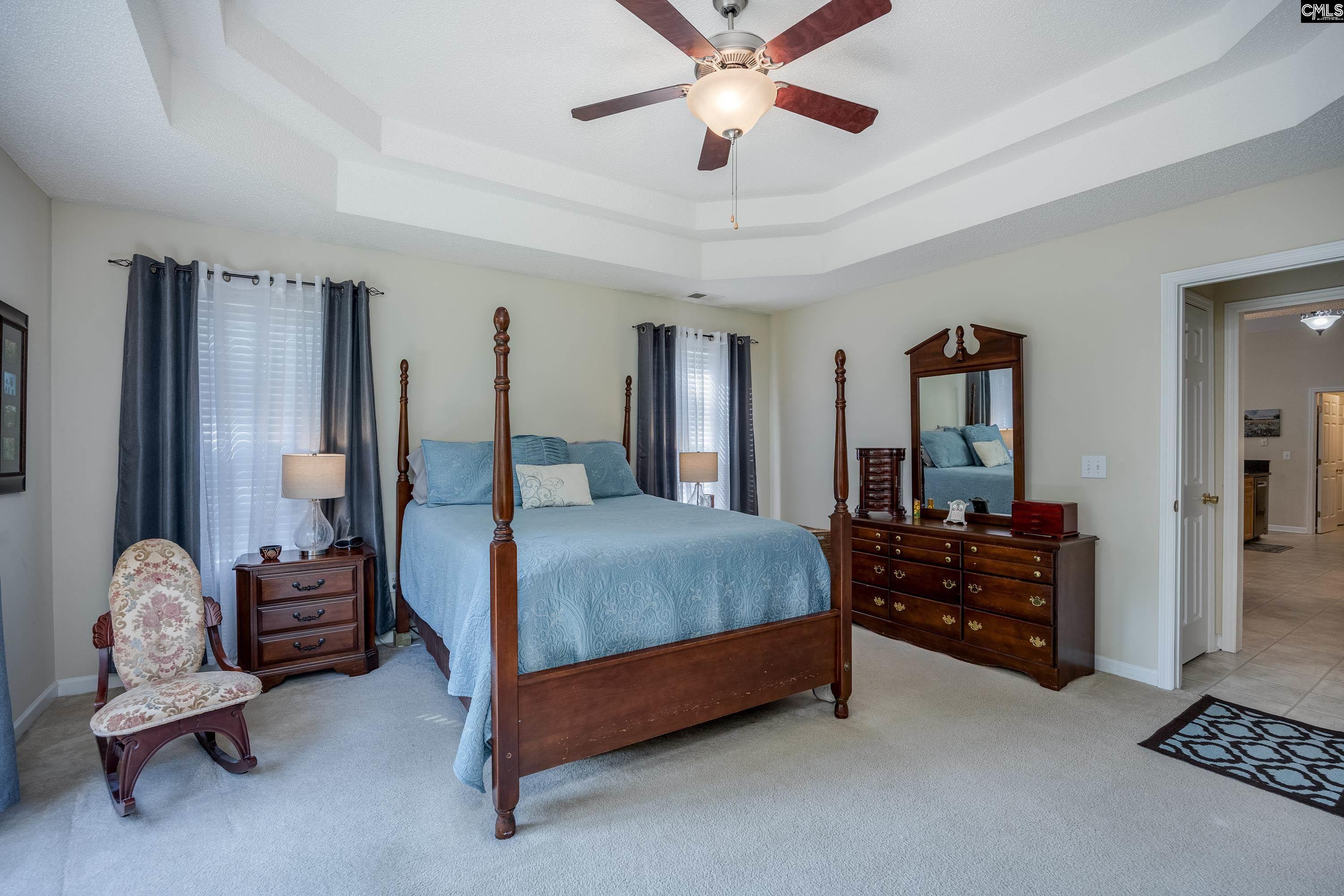 2032 Ridgeway Road Lugoff, SC 29078 - Photo 29 of 57 a bedroom with a bed and a chandelier