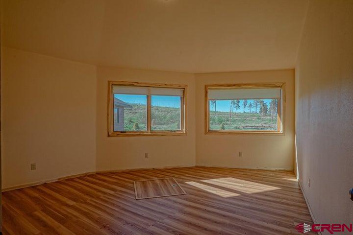 1810 Forbes Park Road Fort Garland, CO 81133 - Photo 12 of 25 a view of an empty room with wooden floor and a window