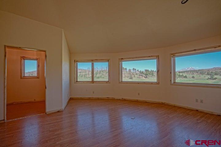 1810 Forbes Park Road Fort Garland, CO 81133 - Photo 13 of 25 a view of an empty room with wooden floor and a window