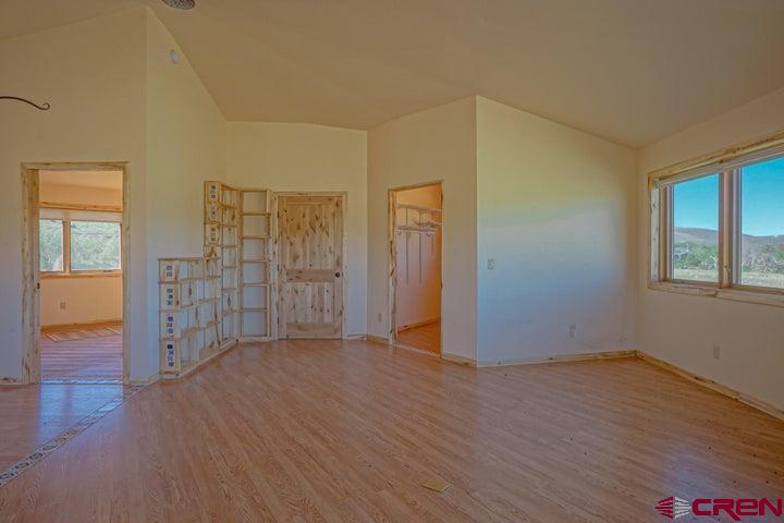 1810 Forbes Park Road Fort Garland, CO 81133 - Photo 14 of 25 an empty room with wooden floor and windows