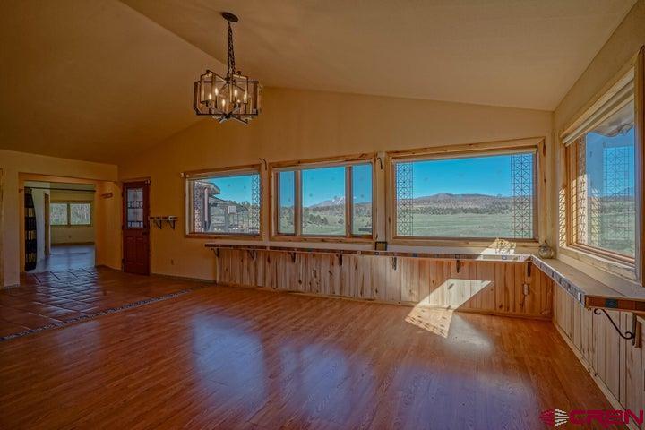 1810 Forbes Park Road Fort Garland, CO 81133 - Photo 16 of 25 a view of an empty room with wooden floor and a window