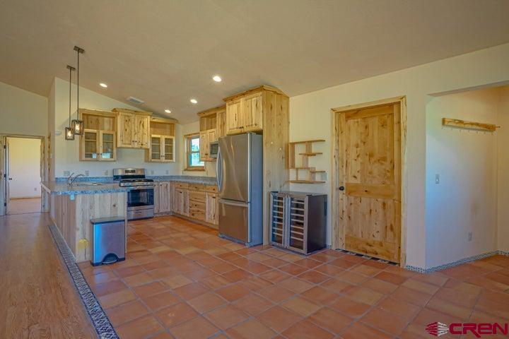 1810 Forbes Park Road Fort Garland, CO 81133 - Photo 19 of 25 a view of kitchen with granite countertop cabinets and refrigerator