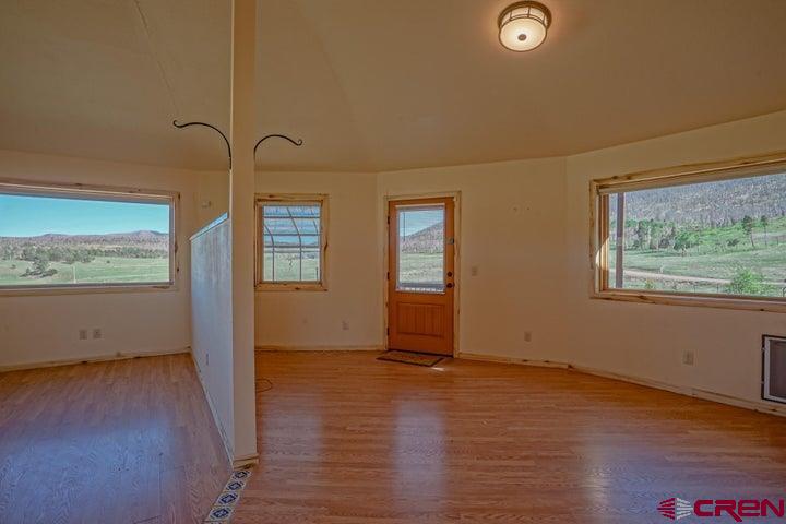 1810 Forbes Park Road Fort Garland, CO 81133 - Photo 22 of 25 an empty room with wooden floor and windows