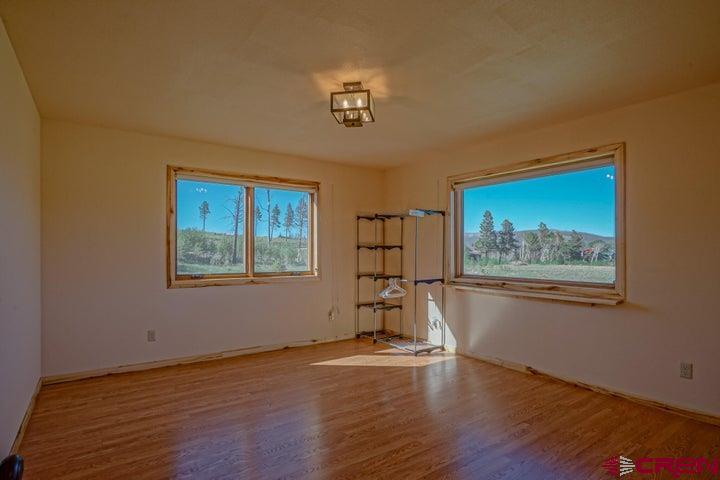 1810 Forbes Park Road Fort Garland, CO 81133 - Photo 4 of 25 a view of empty room with wooden floor and fan
