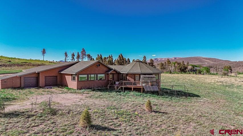 1810 Forbes Park Road Fort Garland, CO 81133 - Photo 5 of 25 a backyard of a house with barbeque oven and outdoor seating