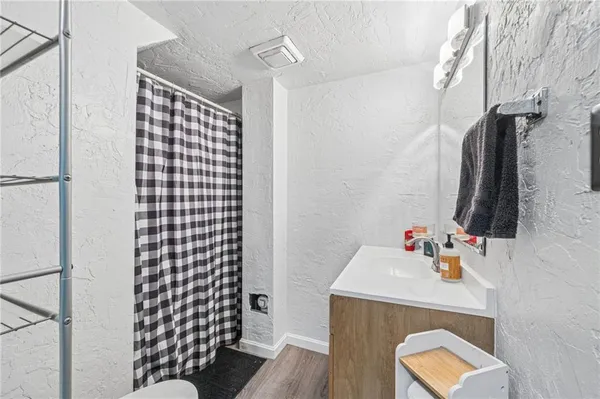 a bathroom with a sink toilet and shower