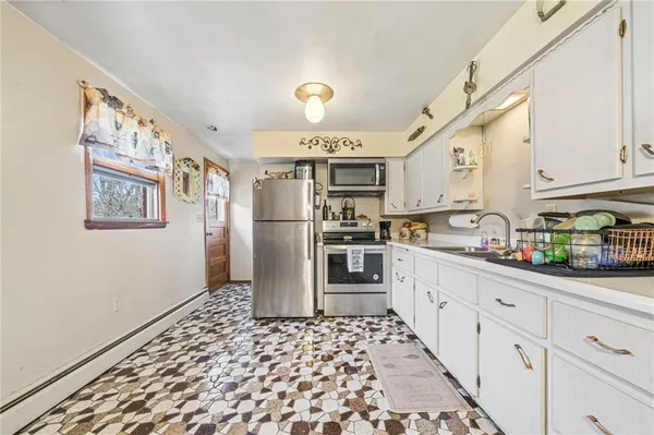 a kitchen with granite countertop a refrigerator and cabinets